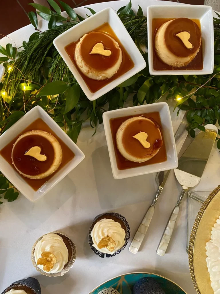 Mini flans with gold hearts on a wedding dessert table