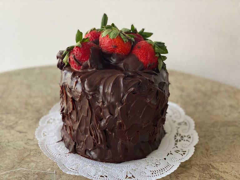 Keto chocolate cake topped with fresh strawberries
