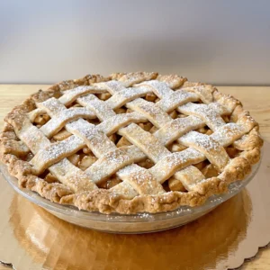 Apple pie with a lattice crust on a gold cake board