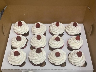 Box of twelve cupcakes with white cream