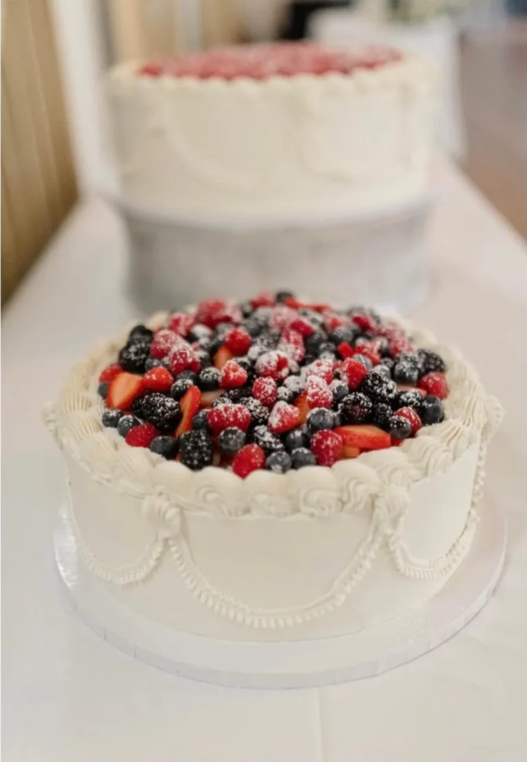 Buttercream cake topped with fresh mixed berries