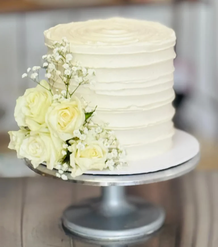 Buttercream rosette cake with ivory roses and baby's breath