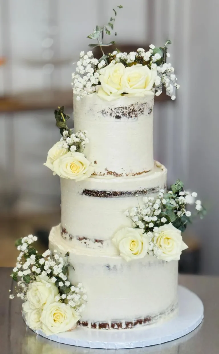 flans & cakes Three-tier semi-naked wedding cake with white roses and baby's breath