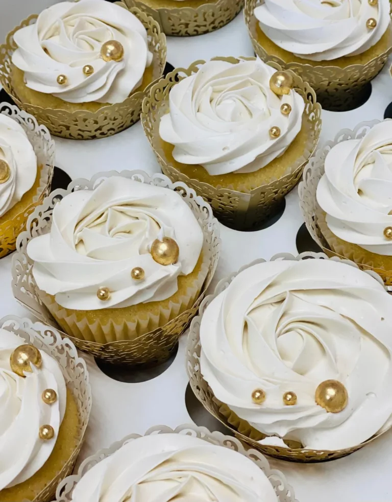 flans & cakes Vanilla cupcakes with white rosette frosting and gold pearls