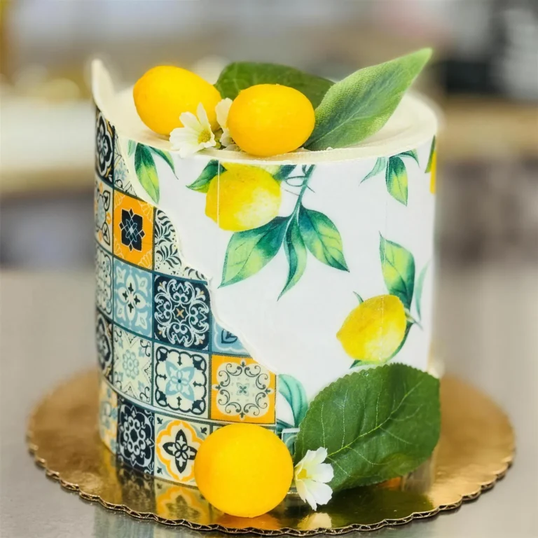 Birthday cake with a blue tile and lemon print, topped with lemons and leaves